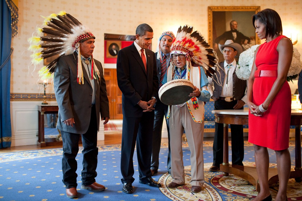Presidential Medal of Freedom recipient Joseph Medicine Crow shows a drum to President Barack Obama and First Lady Michelle Obama during a reception for recipients and their families in the Blue Room of the White House, August 12, 2009. (Official White House photo by Pete Souza) 