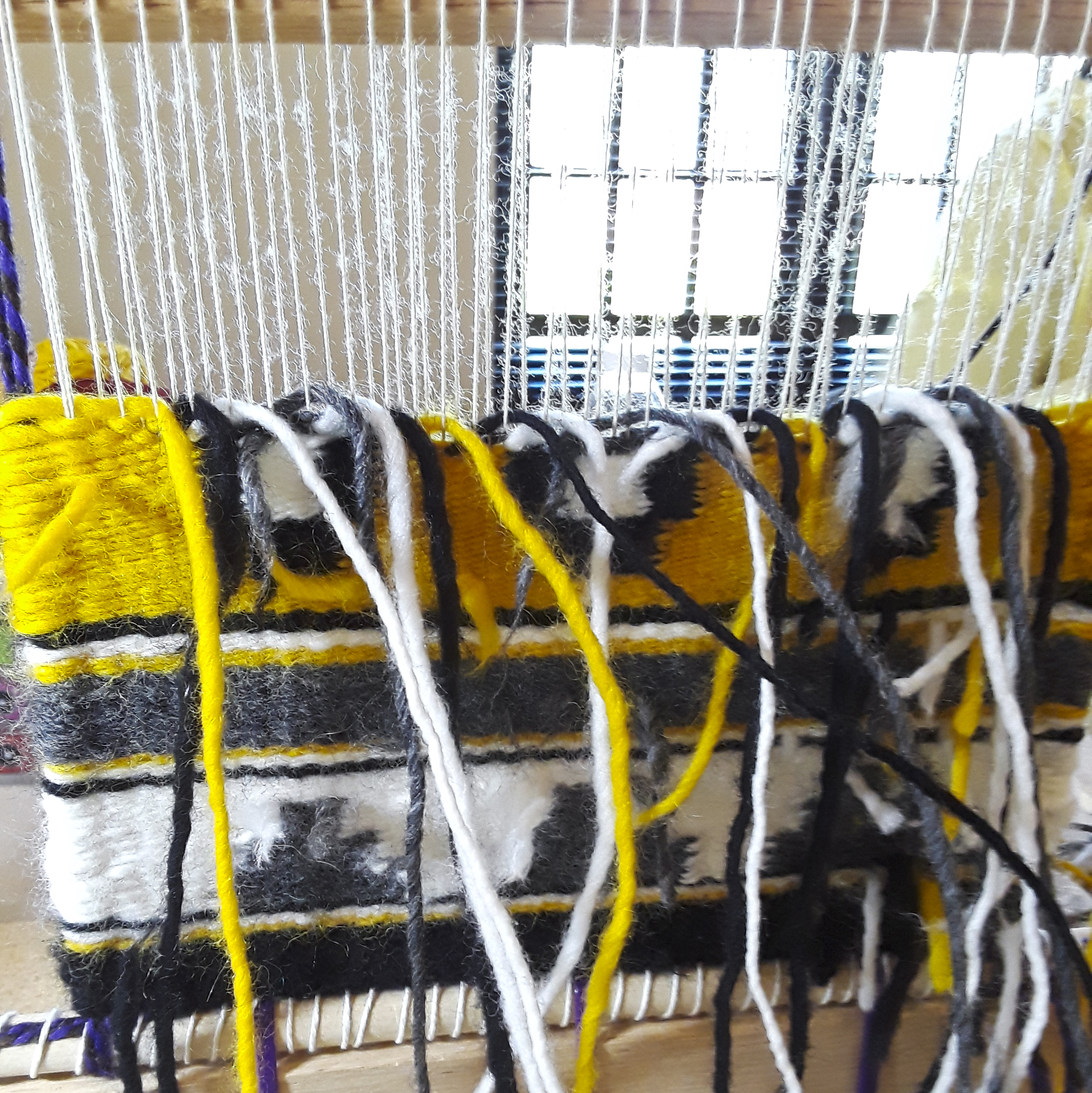 Detailed shot of the yarn woven on a loom.