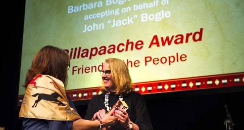 Barbara, the Daughter of Jack Bogle accepts on his behalf the Billapaache Award for his service to the College Fund