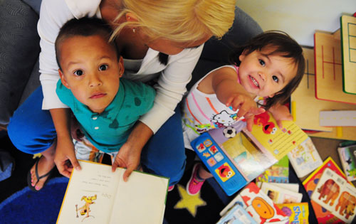 ECE learners at the NWIC center in Beliingham, WA look up at the camera.