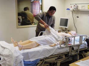A Navajo Technical College (NTC) nursing student demonstrates in the lab during a tour for the American Indian College Fund staff. NTC graduated their first class of nurses this past year.