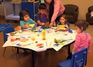 Children painting and learning about oyster and clam shells.