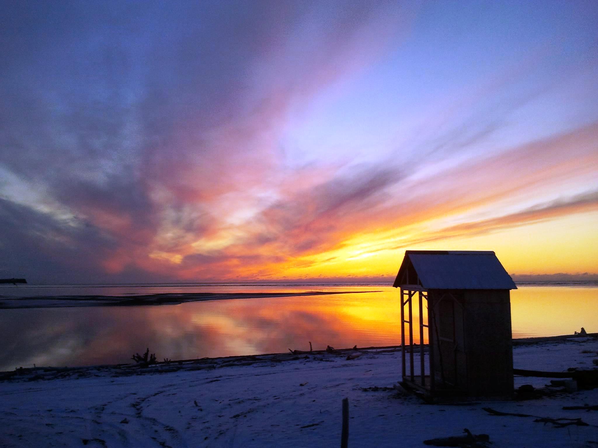Smokehouse with winter sunset in Unakleet