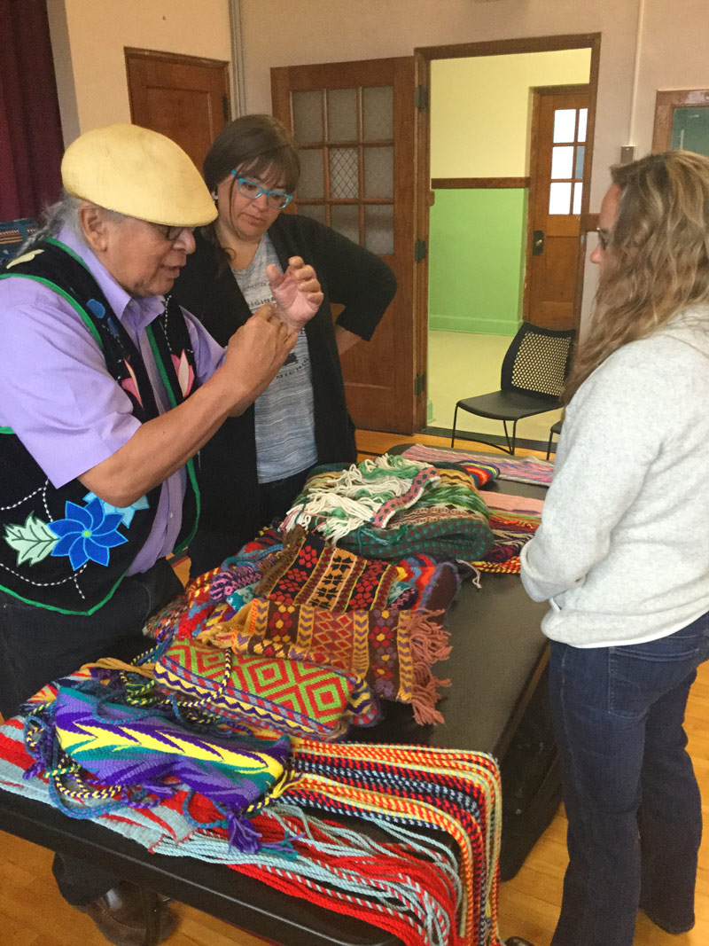 Dennis White, Oreilles tribal member and elder, demonstrates the mathematics in his finger-woven patterns.