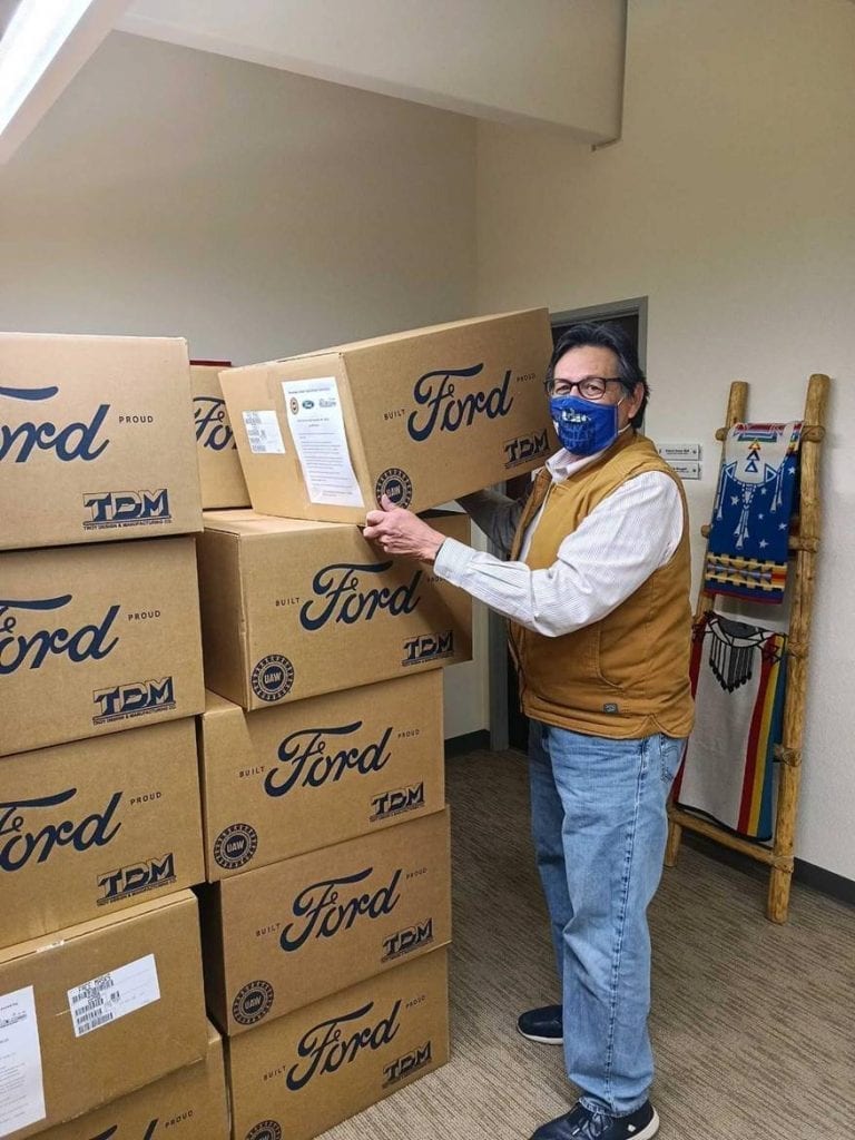 Denver Indian Center Co-Executive Director Rick Waters (Kiowa and Cherokee of Oklahoma) unloads a delivery of personal protective equipment from the Ford Motor Company Fund and the American Indian College Fund.