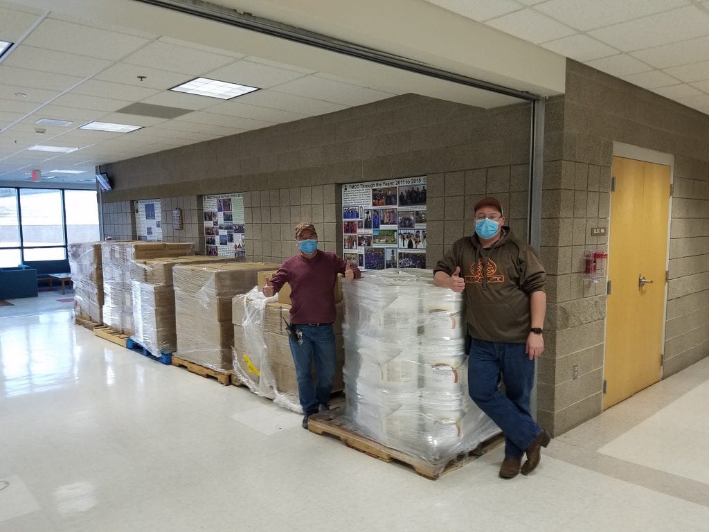 Photo 1: Albert Gourneau (left) and Anthony Desjarlais (right) from Turtle Mountain Community College’s facilities department prepare to distribute sanitizing supplies and safety equipment at the tribal college campus in Belcourt, North Dakota.