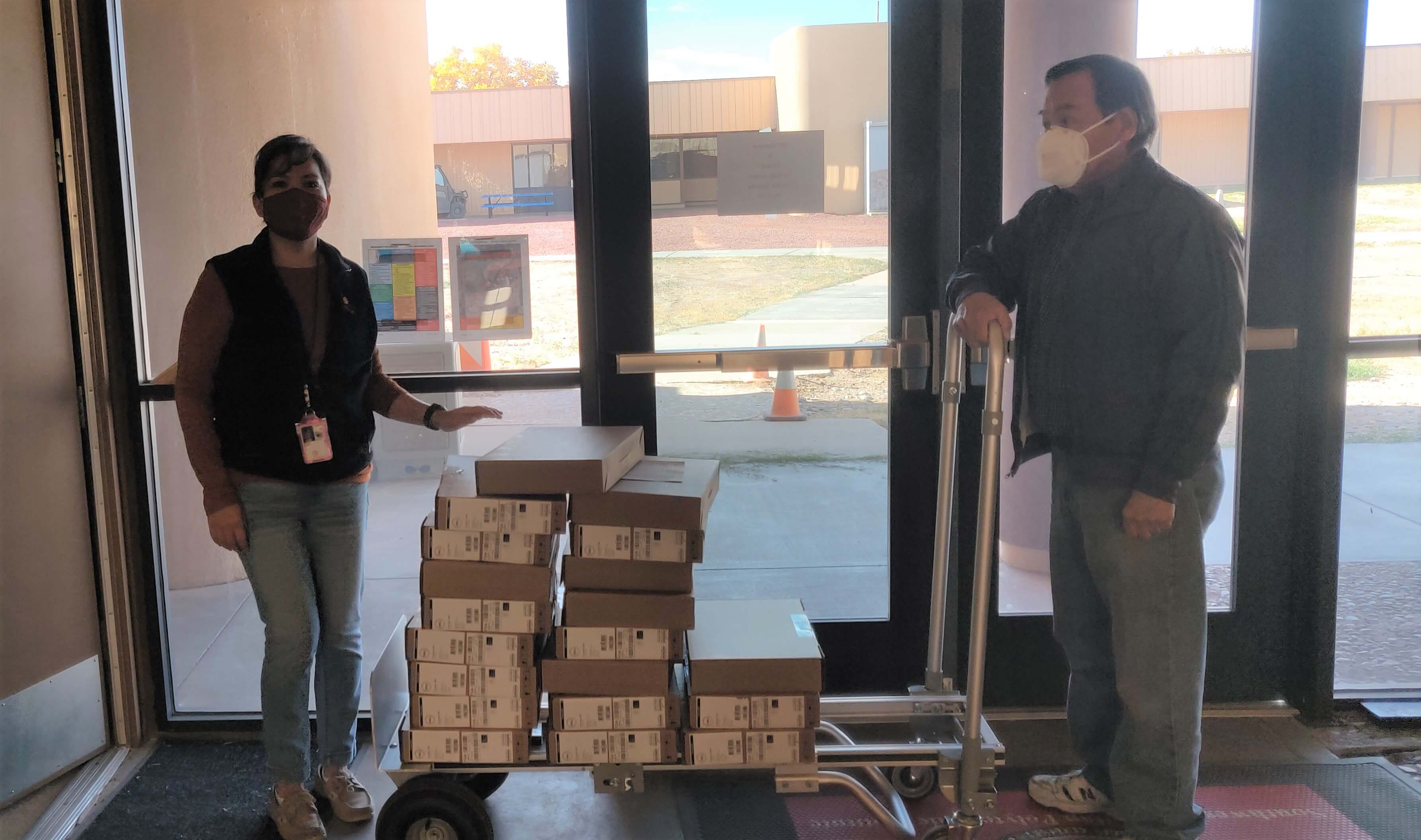 SIPI staff, Bobbi Brown and Dennis Dyer, mail out laptops to HSE students