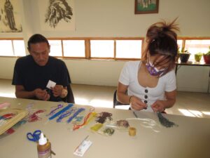McKayla working on a beaded lanyard during her apprenticeship with Ivan.