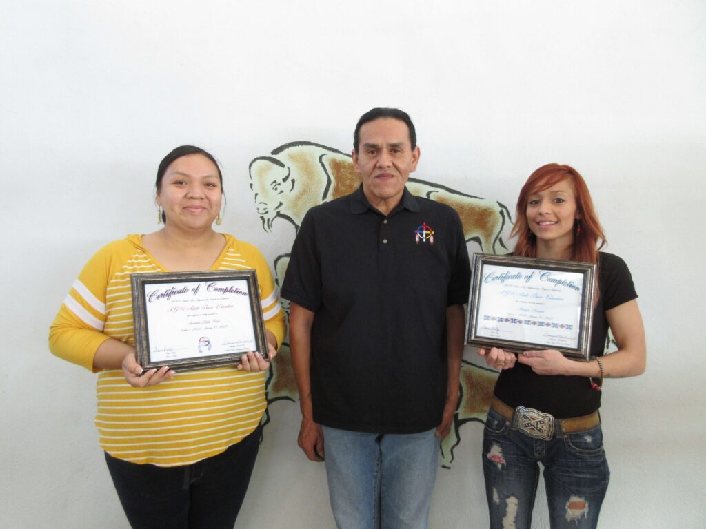 Savanna Littlebird (left) and McKayla Burnette (right) receiving their certificate of completion with Master Artist, Ivan Knife (center) at the conclusion of their apprenticeships.
