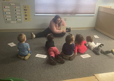 Early Childhood student, Kira, reads to a KBIC Preprimary program class room.