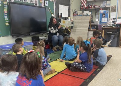 Early Childhood student, Melissa, reads to a Baraga Area Schools elementary class room.