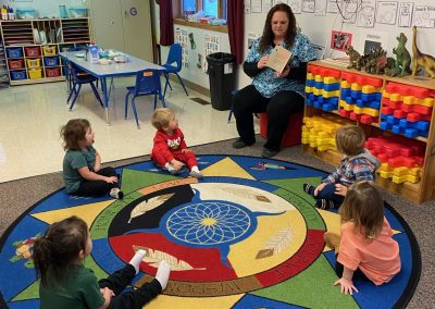 Early Childhood student reads to a classroom at KBIC Early Head Start.