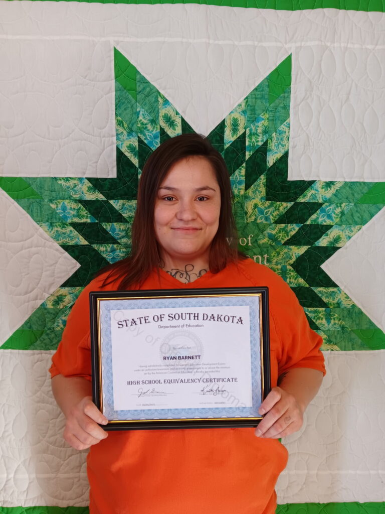 Ryan holding a copy of her HSE certificate