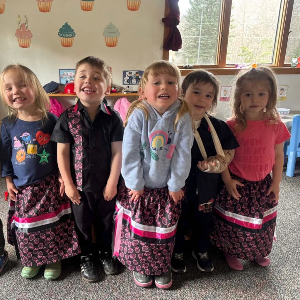  Five Keweenaw Bay Indian Community early head start students preparing for the Children’s Pow Wow in their regalia.